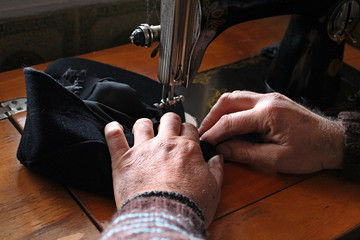 a man sews a shaker on a machine