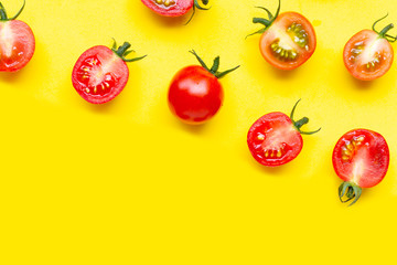 Fresh tomatoes, whole and half cut isolated on yellow background.