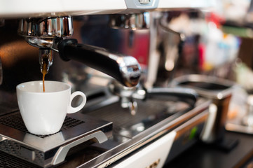 black coffee in white cup on coffee maker