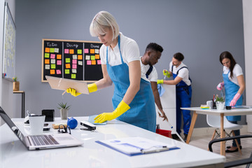 Happy Janitors Cleaning Office