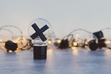 decision making, bad idea rejected and crossed out surrounded by other light bulbs lit up