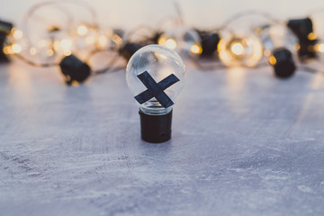 decision making, bad idea rejected and crossed out surrounded by other light bulbs lit up