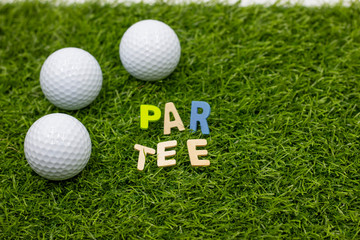 Golf party invitation par tee golf ball with colorful tee on green grass