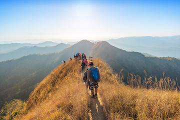 beautiful landscape with trekkers walking on mountain ridge in sunset at Thong Pha Phum National...