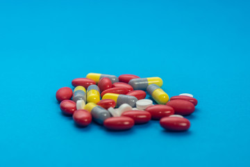 Pills, drugs on colorful background. Healthcare concept. Shallow depth of field, soft focus