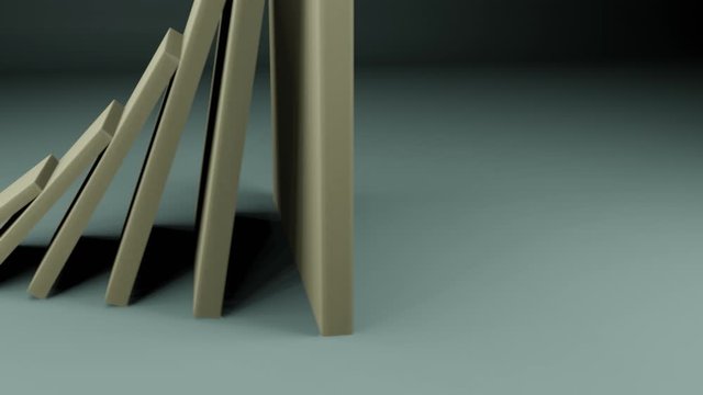 Falling domino pieces of increasing sizes falling. Cause and effect concept. Action and reaction concept. Root cause concept