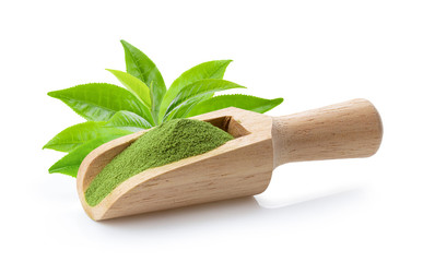 matcha green tea powder in wood scoop with leaf on white background