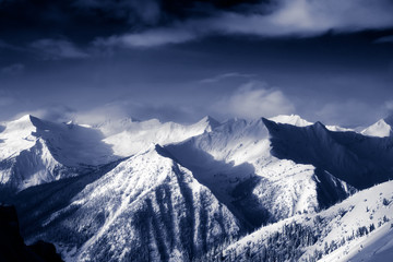 Fototapeta na wymiar Kicking Horse, Golden, British Columbia, Canada. Beautiful Aerial View of Canadian Mountain Landscape during a vibrant sunny and cloudy morning sunrise in winter.
