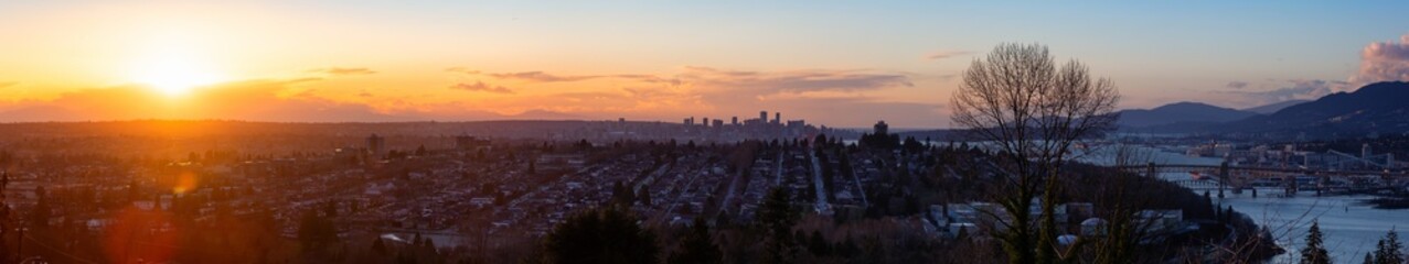 Fototapeta premium Burnaby, Greater Vancouver, British Columbia, Canada . Beautiful Panoramic View of the city from the top of the hill during a colorful winter sunset.