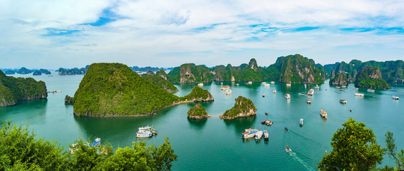 Aerial view of Ha Long Bay; with a lot of limestone islets and cruise ships; on a cloudy summer day.