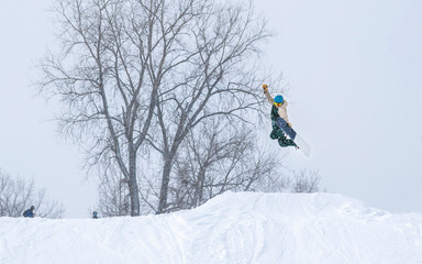 People are having fun in downhill skiing and snowboarding in the middle of snowfall 