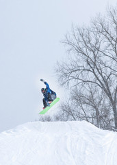 People are having fun in downhill skiing and snowboarding in the middle of snowfall 