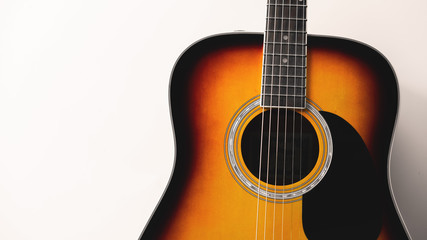 Obraz na płótnie Canvas Close-up acoustic guitar on white wall background, vintage filter.