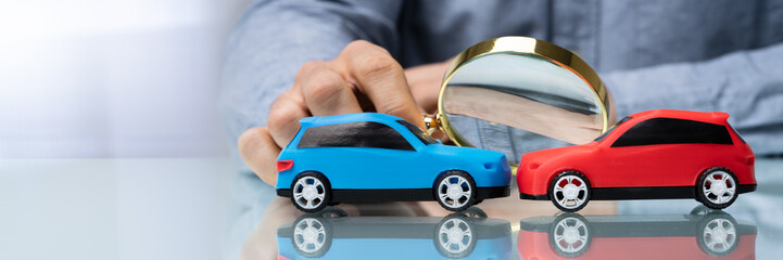 Close-up Of Two Wooden Car On Desk