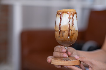 hand with glass of red wine