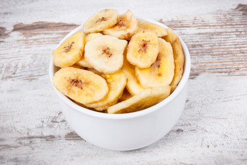 Banana chips in bowl as natural snack for dessert