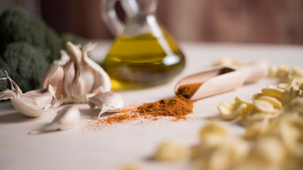 Close-up of typical Italian Apulian fresh pasta orecchiette on a table with broccoli, garlic, oil and chilli powder 