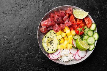 Raw organic ahi tuna poke bowl with rice and veggies