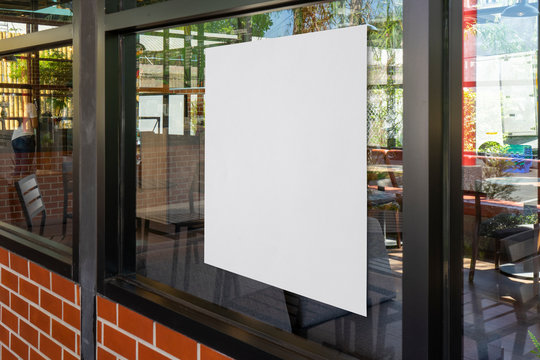 Mock-up billboard or white paper poster promotion  display on the front restaurant or coffee shop. Blank paper for Promotion information for marketing announcements and details.