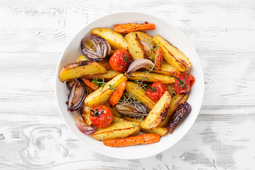 Roasted vegetables in a white plate. Vegetarian dish.