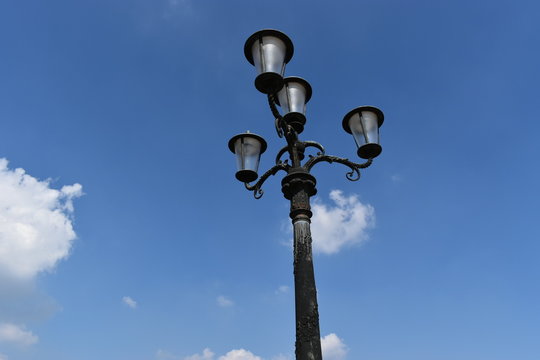 Image of old street lamp on blue sky