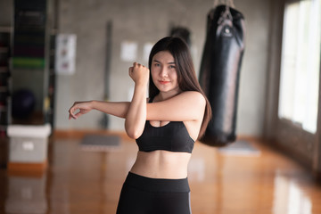 Fototapeta na wymiar sport women stretching before exercise in the gym