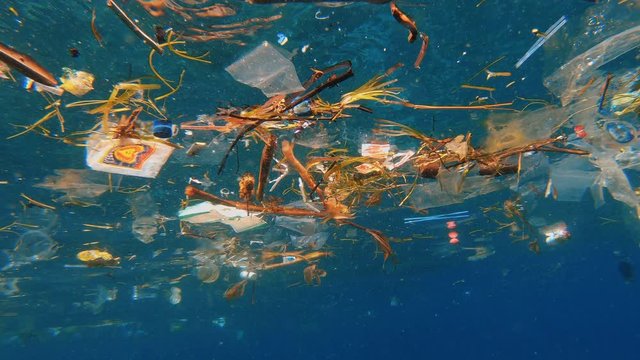 Trash in sea water, plastic pollution problem in tropical waters of Indonesia near Nusa Penida island
