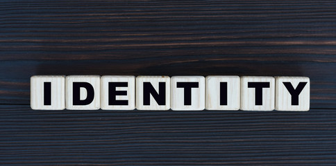 Obraz premium concept word identity on cubes on a beautiful dark wooden background