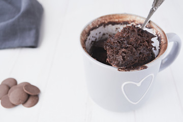 Homemade chocolate mug cake on a white background