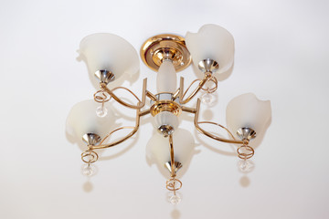 Ceeling lamp with gold anodation and copy space. Post soviet era legasy lifestyle concept.