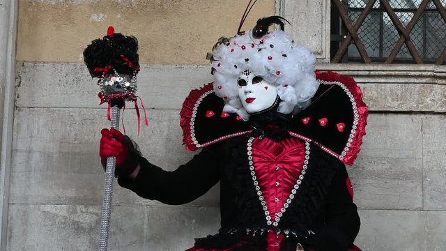 February 2020 Venice Carnival, Italy - carnival masks are photographed with tourists in Piazza San Marco