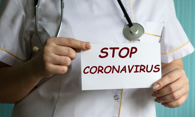 concept words stop coronavirus in the hands of a doctor