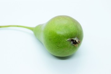 Ripe beautiful green pear is located on a white background