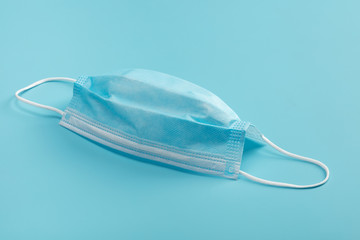 Medical mask on blue background.