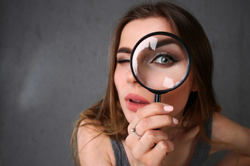 Young beautiful woman portrait looks painful eye lens search on Internet information employer does...