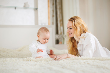 young mother tenderly hugs her little cute baby