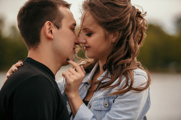 Fototapeta premium Young beautiful couple walking along the waterfront / Lifestyle