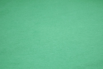 Fototapeta na wymiar Green Mint surface cotton fabric - Waving backdrops texture background of clothing 