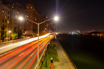 Urban manhattan New York City east side highway with red and whitte streaks of car light traffic