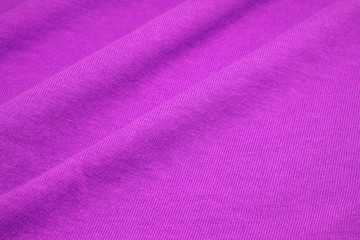 Fototapeta na wymiar Purple Violet surface cotton fabric - Waving backdrops texture background of clothing 