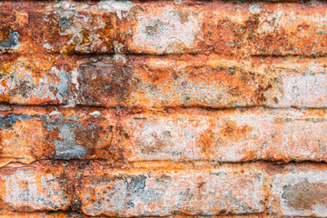 Red vintage wall with damaged brick. Vibrant abstract wallpaper, banner.