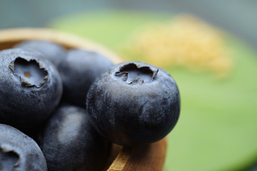 Macro fresh ripe blueberries in wooden container