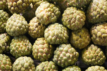 Fototapeta premium Fruit scene - fresh raw sweetsop, custard apple in market - backdrop and beautiful detail