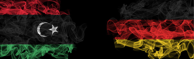 Flags of Libya and Germany on Black background, Libya vs Germany Smoke Flags
