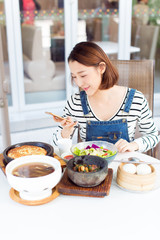 Happy woman eating out in a restaurant stock photo
