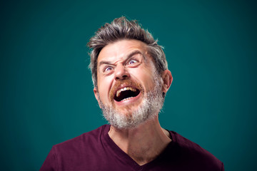 A portrait of angry and crazy screaming man. People and emotions concept