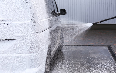 Covering automobile with foam at car wash