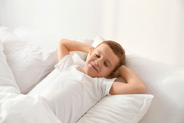 Obraz na płótnie Canvas Cute little boy sleeping in bed at home