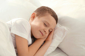 Fototapeta na wymiar Cute little boy sleeping in bed at home