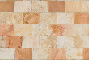 smooth wall of sandstone tiles with different shades